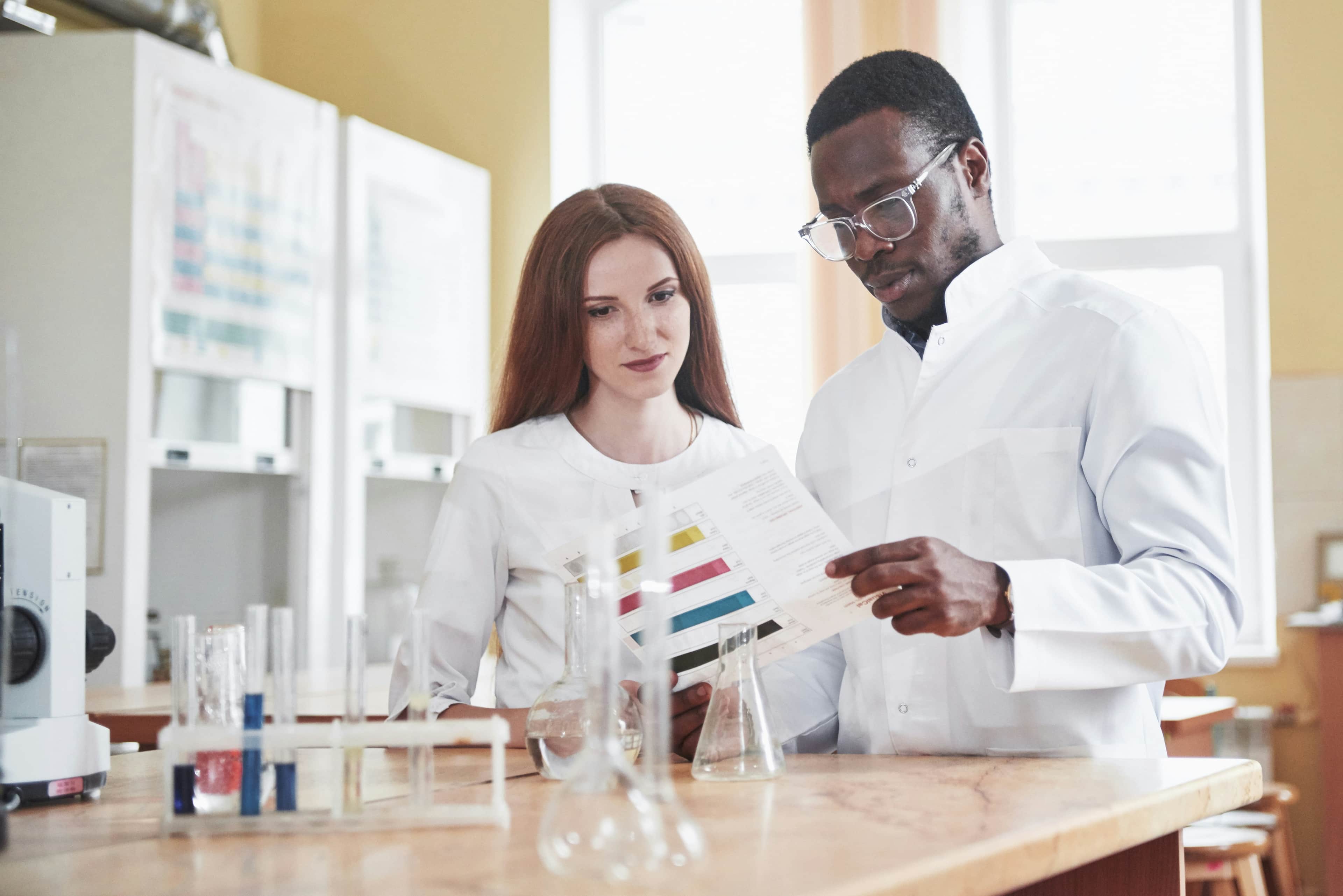 Laboratory professionals reviewing compliance documentation